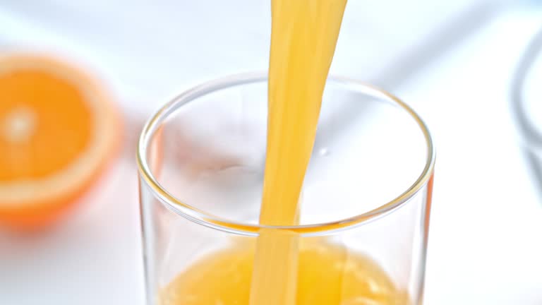 SLO MO Orange juice being poured into a glass