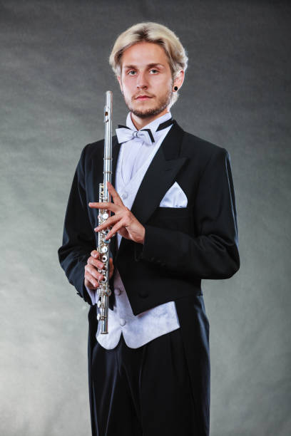 istock Elegantly dressed musician holding flute 889786170