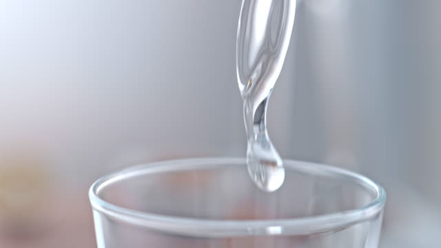 SLO MO Spurt of water flowing into a glass