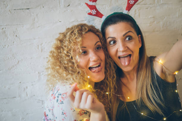 istock Two happy pretty girls making selfie and smiling 889798200