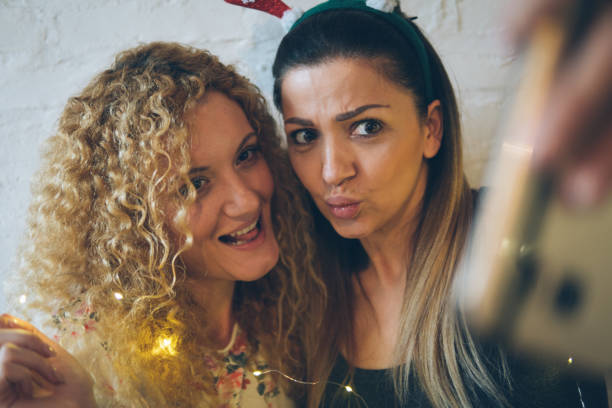 istock Two happy pretty girls making selfie and smiling 889798286