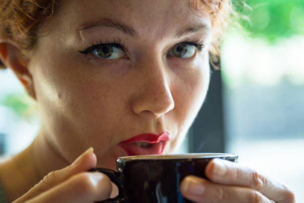 istock Woman Blowing on Coffee 889798542