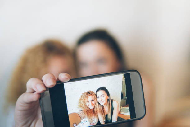 istock Two happy pretty girls making selfie and smiling 889798740