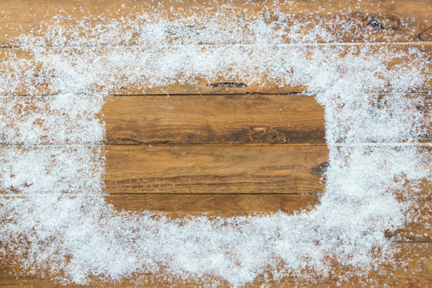 istock Christmas snow border frame over wooden background. Space for text 889809026