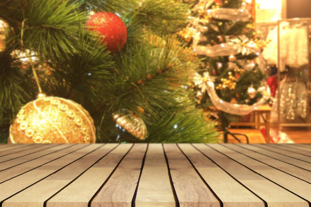 istock Perspective empty wooden table and christmas tree with snowing and blur decoration at coffee shop background, for product display montage or design layout. 889809378