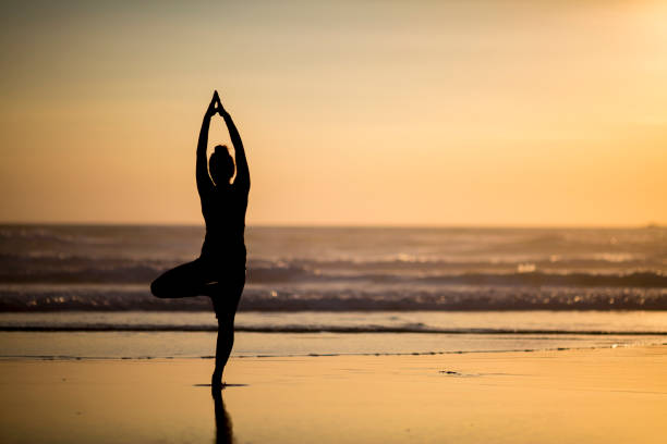 istock Woman doing meditation at sunset 889811740
