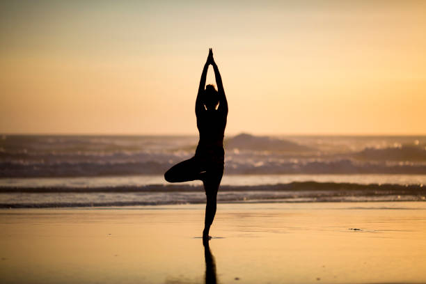 istock Woman doing meditation at sunset 889811826