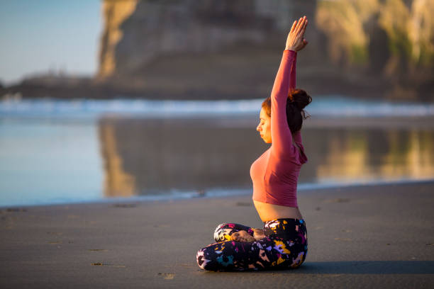 istock Woman doing meditation at sunset 889814370