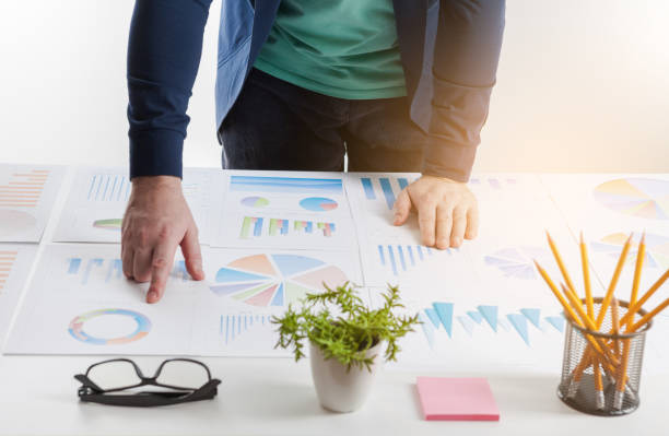 istock Stock market chart and finger pointing on tablet in office 889814530