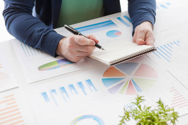 istock Stock market chart and finger pointing on tablet in office 889814532