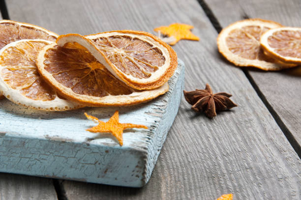 istock Dried orange on old wooden background 889819500