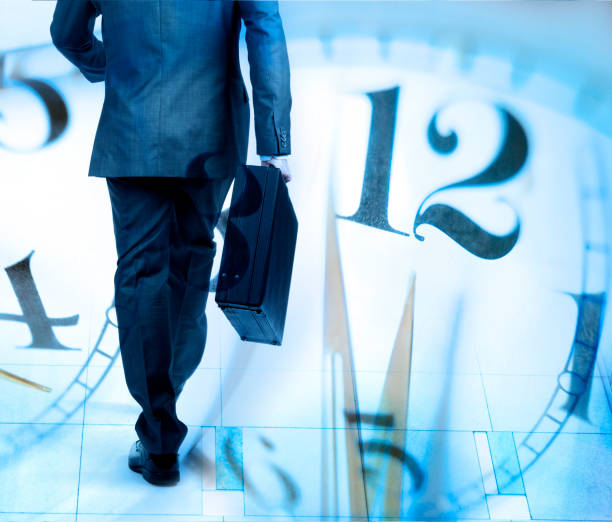 istock Montage Of Businessman Walking And Several Clock Faces 889823854