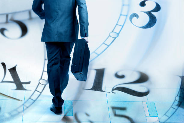istock Montage Of Businessman Walking And Several Clock Faces 889823856