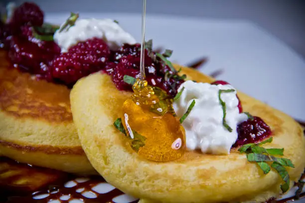 Warm hotcakes, honey syrup motion and berries compote
