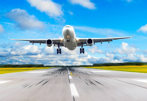 istock Passenger airplane fly up over take off runway from airport. 889857150