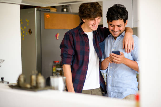 istock Gay couple using mobile phone. 889889570