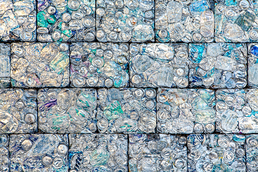 A wall of crushed aluminum cans recycled into building blocks.