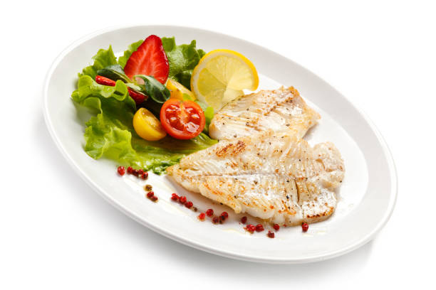 istock Fish dish - fried fish fillet and vegetables 889910924