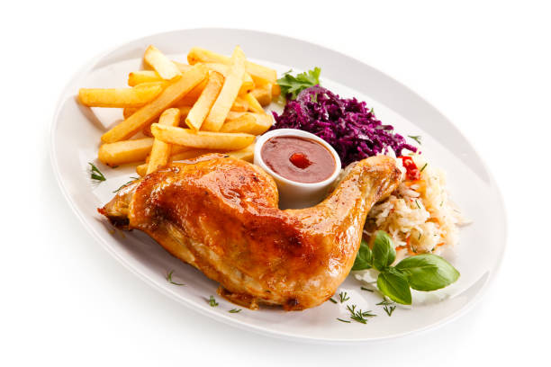 istock Grilled chicken leg with chips and vegetables 889920030