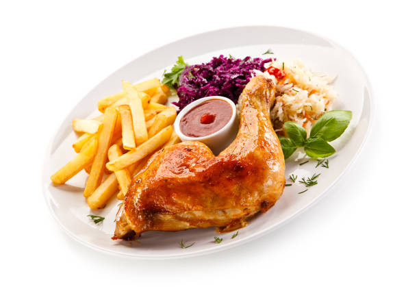 istock Grilled chicken leg with chips and vegetables 889920050
