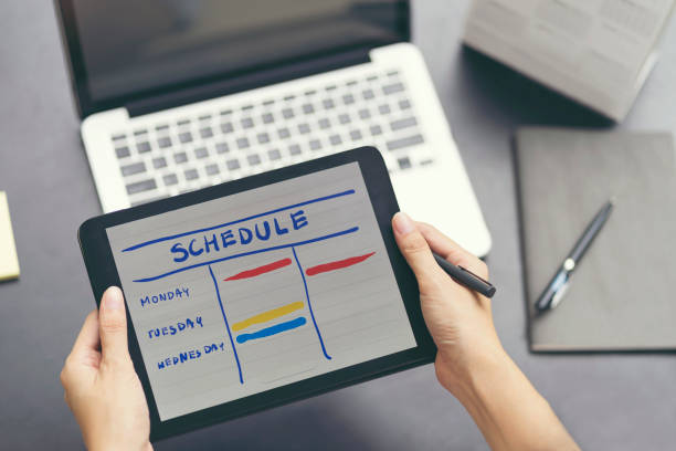 istock Woman planning agenda and schedule using calendar event planner. Woman hands using plan to vacation on laptop computer. Calender planner organization management remind concept. 889940952