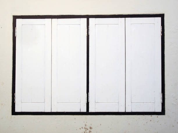 istock Thai old wooden door with white wall 889956094