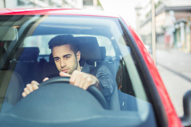 istock Businessman driving a car 889956286