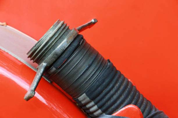 Fire water hose connector on fire truck. Fireman fire truck hose faucets in a row red and silver.