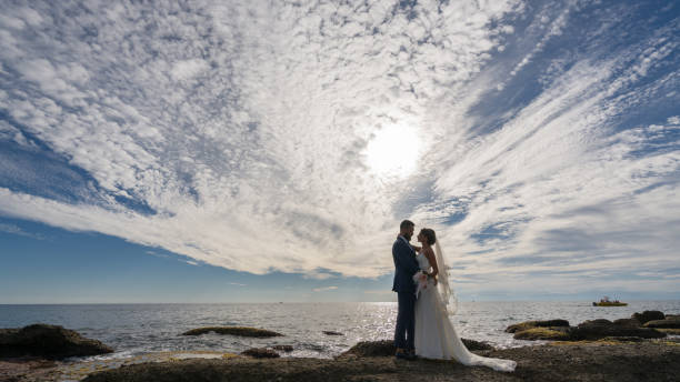 istock Young married couple on the beach by sunset. 889968748