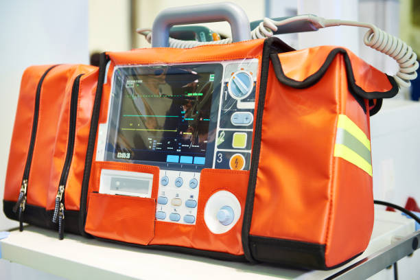 Modern portable biphasic defibrillator Modern portable biphasic defibrillator in orange bag defibrillator photos stock pictures, royalty-free photos & images
