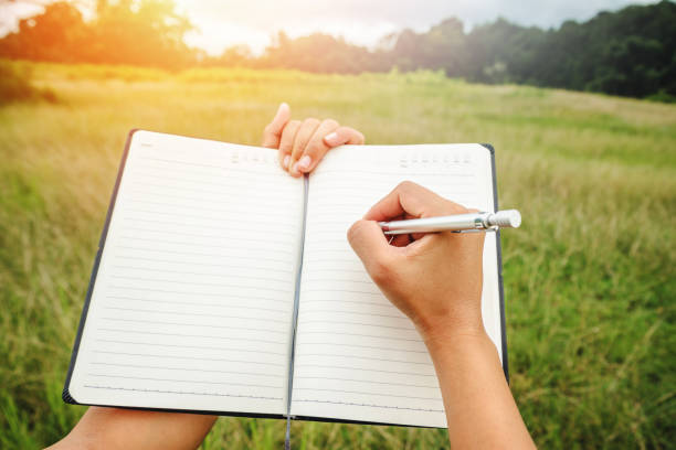 Handwriting on notebook relax in the holiday. on a green pasture.