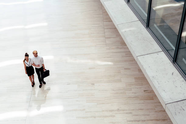 istock Business couple walking together 889981228