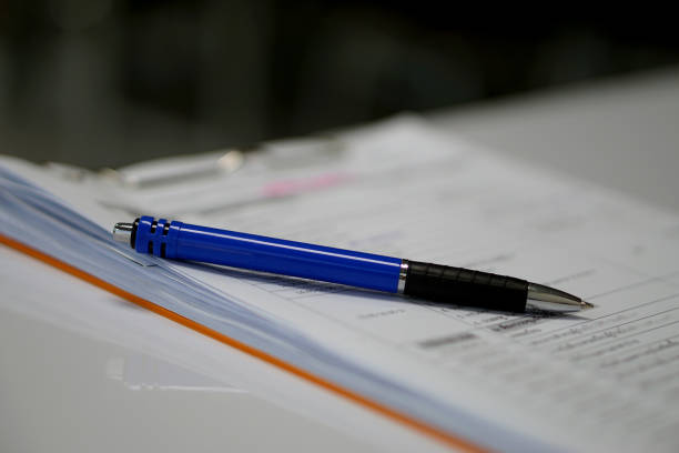 istock Blue pen on document white paper. office supply and business concept 889987122