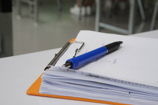 istock Office supply and business concept, blue pen on document white paper. 889991736