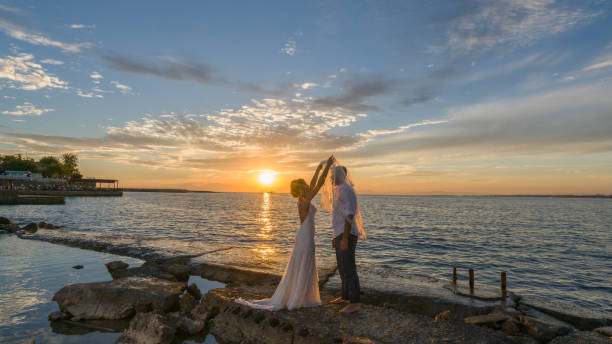 istock Young married couple on the beach by sunset. 890000916