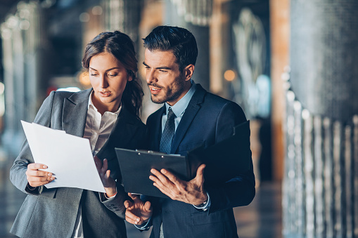 Business persons looking at documents