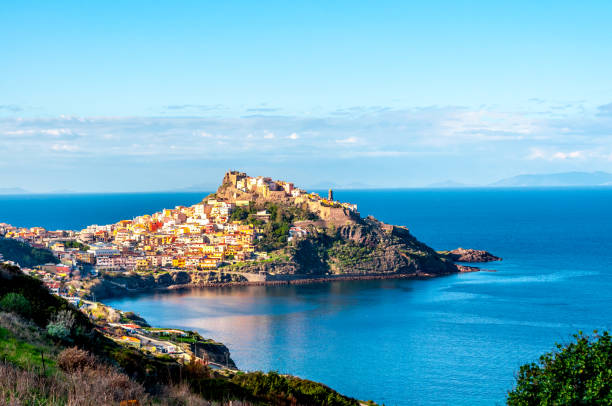 View of ancient village on the coast View of ancient village of Castelsardo - Sardinia in a cloudy day of spring sardinia stock pictures, royalty-free photos & images