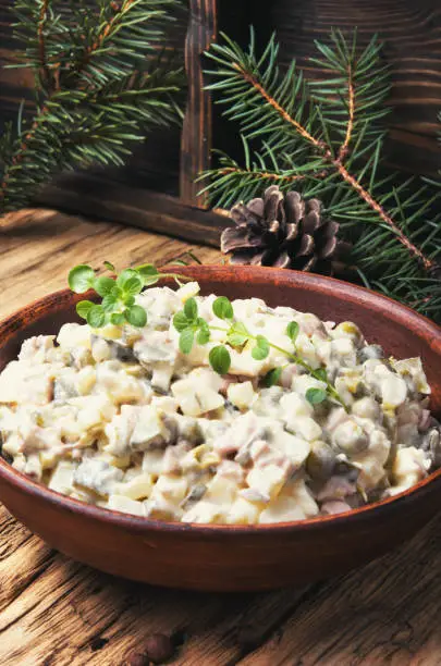 traditional Russian salad Olivier, with meat and vegetables.