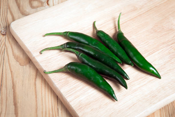 istock pile of green chilli on a wood block 890010096