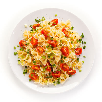 Pasta with meat and vegetables on white background