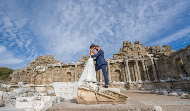 Young married couple in antique city side over temple of  Apollo Young married couple in antique city side standing over temple of  Apollo kourion stock pictures, royalty-free photos & images