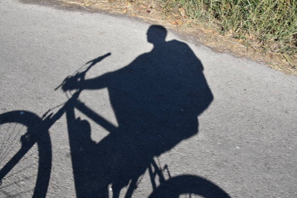 istock Shadow of a man riding a bicycle 890015754