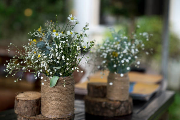 istock Baby daisy flower vase decorated with rope on the table 890025116