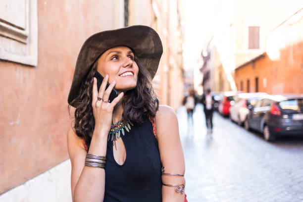 istock Elegant woman with hat talking on phone 890073428