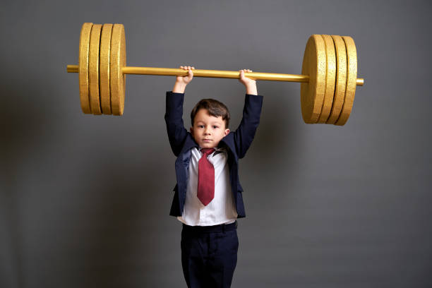 istock Cute business boy lifting gold barbell 890075508