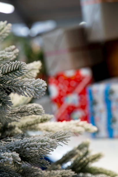 istock christmas tree in the foreground with presents in the background 890080966