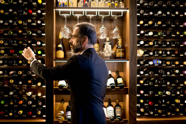 istock Man chooses a bottle of wine 890082982