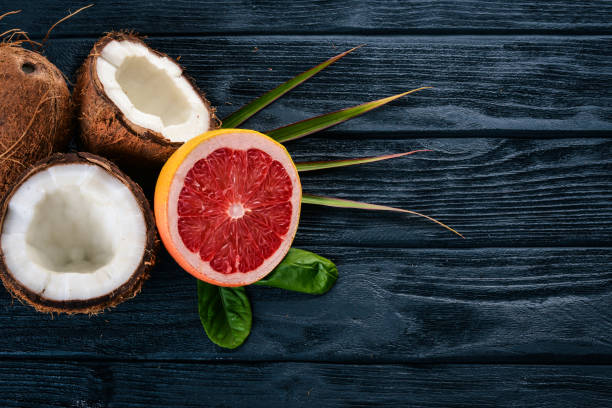 istock Coconut and grapefruit. Fresh fruits. On a wooden background. Top view. Free space for text. 890093146