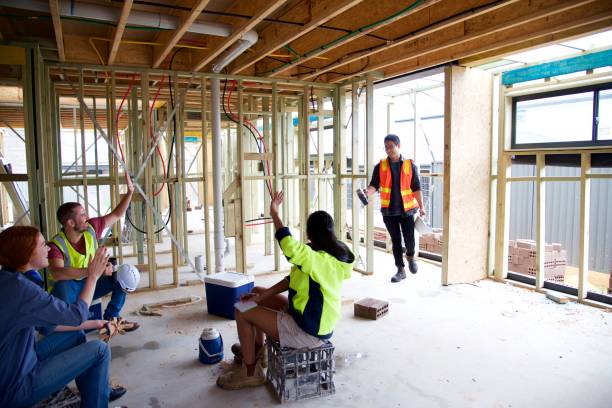 istock SYD112017 Arrival of the boss, diverse construction workers sitting down having a meeting 890101668