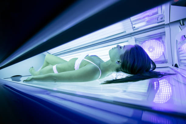istock Beautiful brunette sunbathing in solarium 890105004